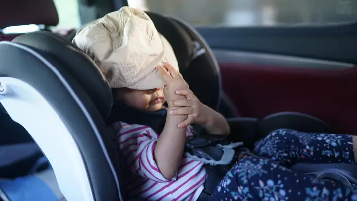 Child safely buckled into a car seat