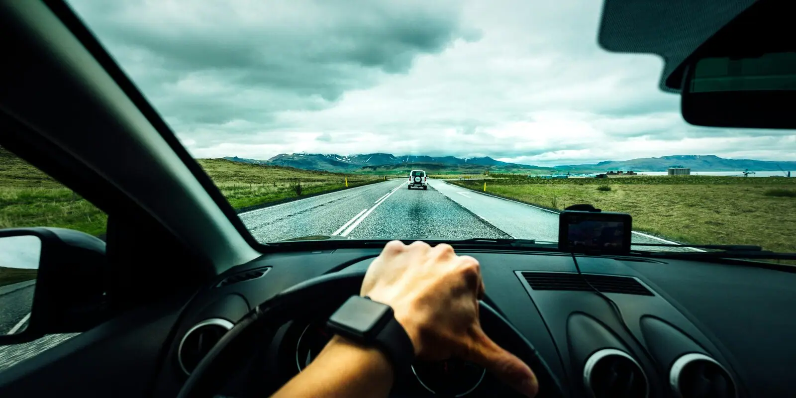 Hands on the steering wheel on a European road